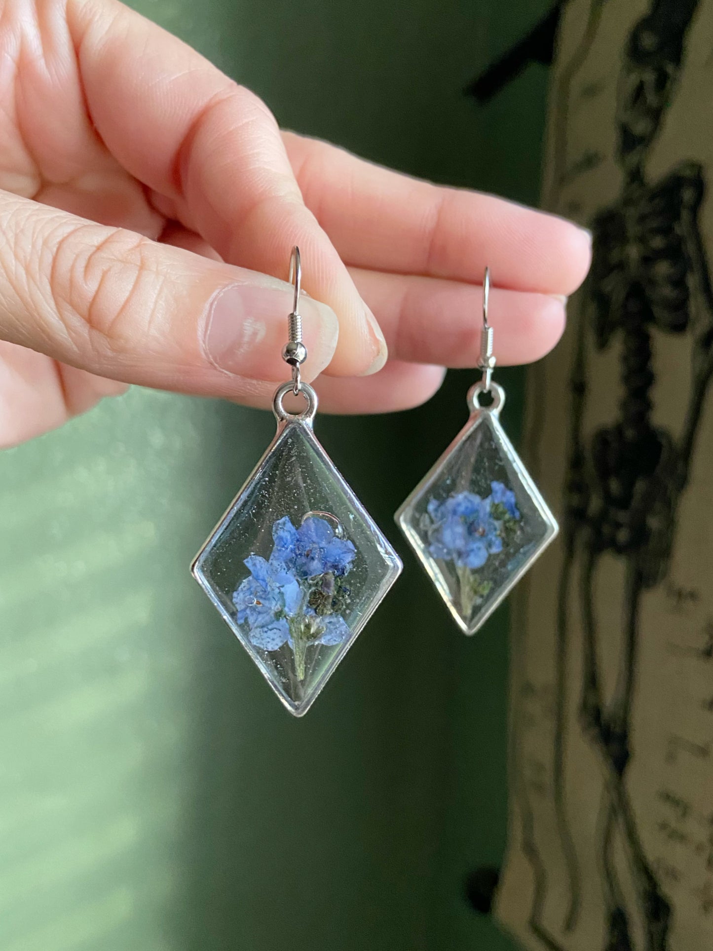Forget Me Nots- Real blue flower clusters inside open silver diamond-shaped earrings