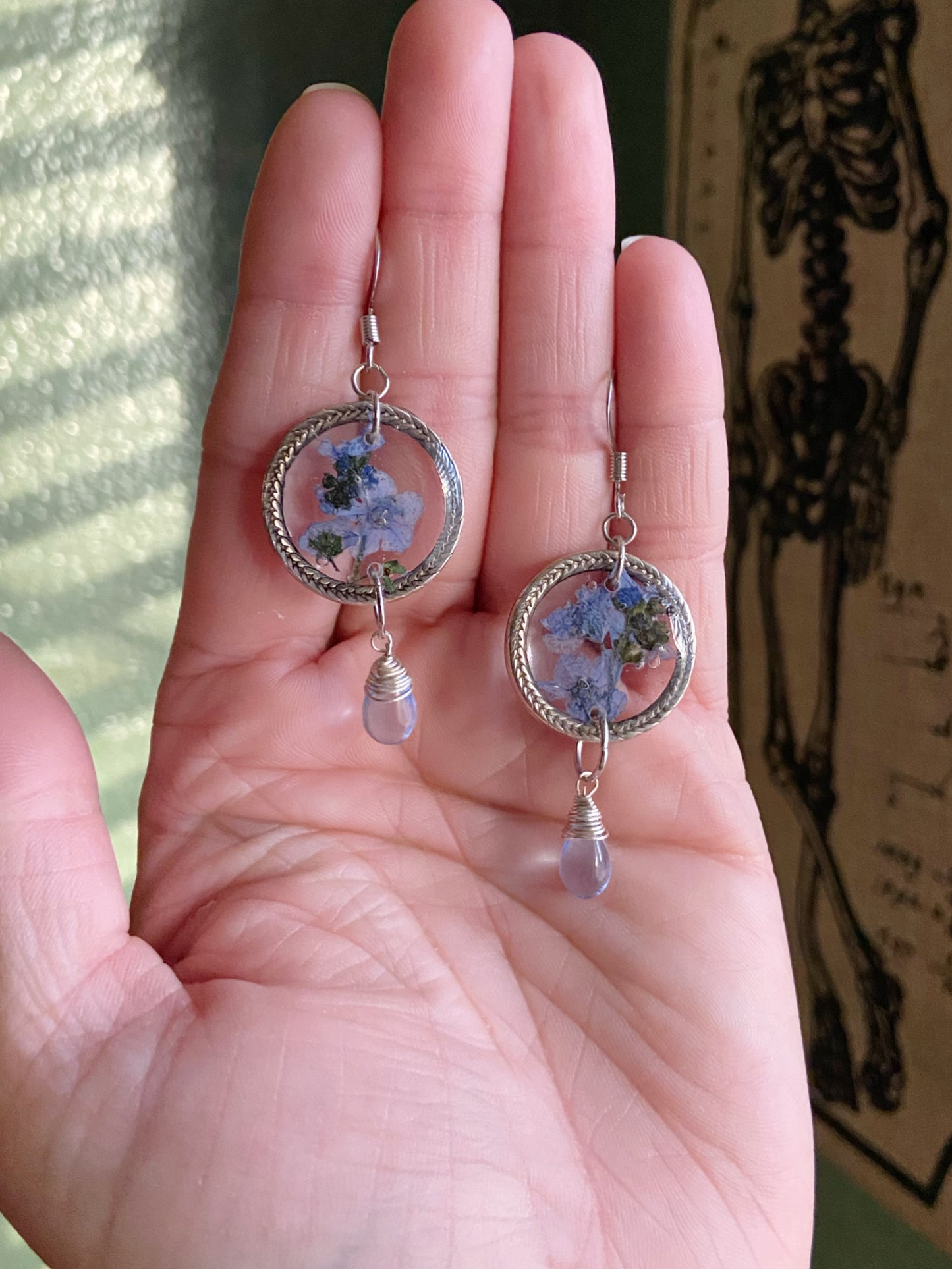 Forget Me Nots- Real blue flower clusters inside open silver leaf-patterned circle earrings with blue glass drop beads