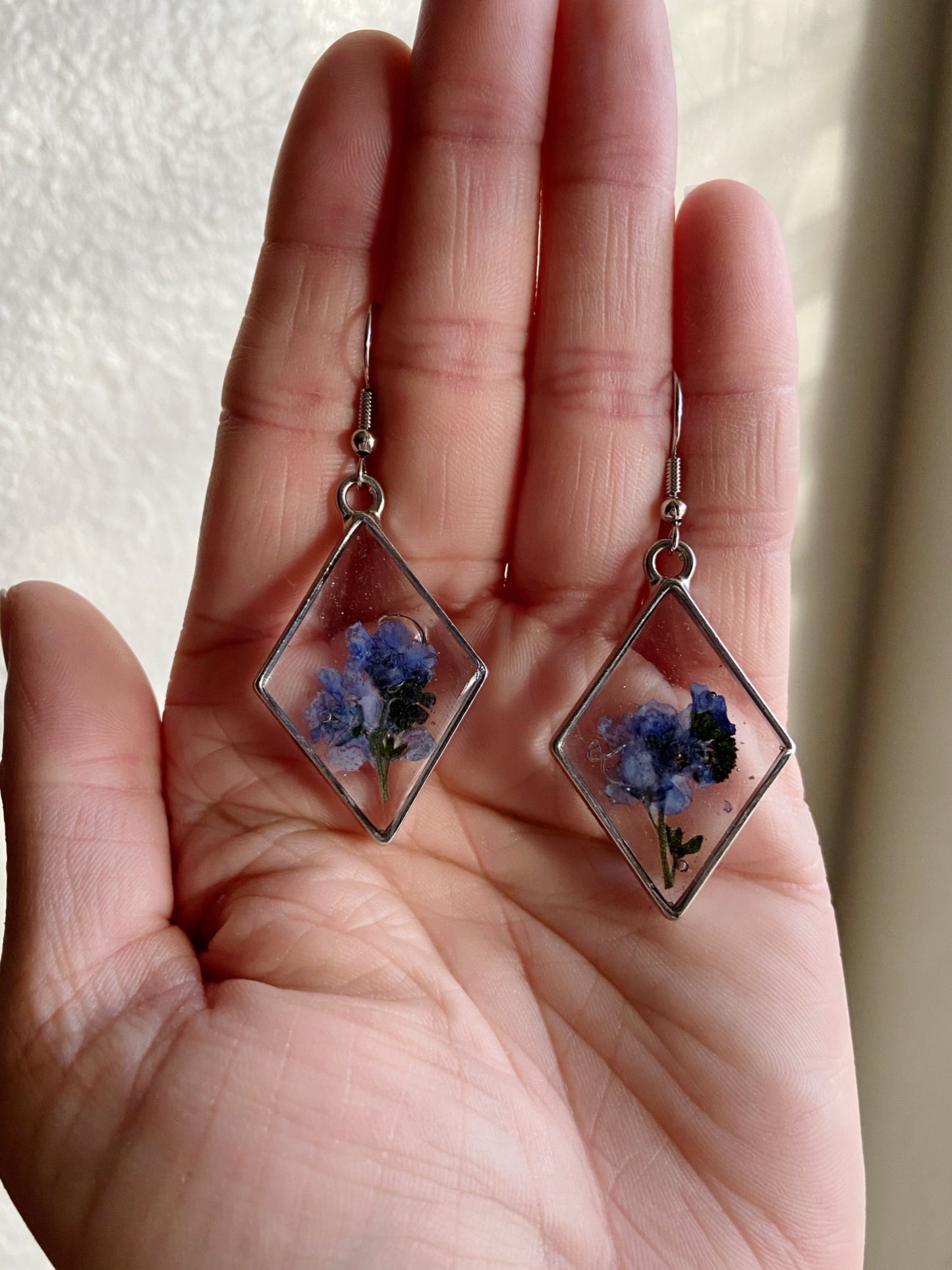 Forget Me Nots- Real blue flower clusters inside open silver diamond-shaped earrings