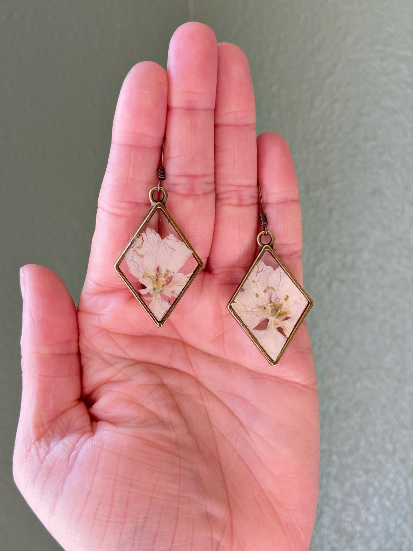 Larkspur- White pressed flowers inside bronze diamond shaped earrings, botanical nature lover jewelry