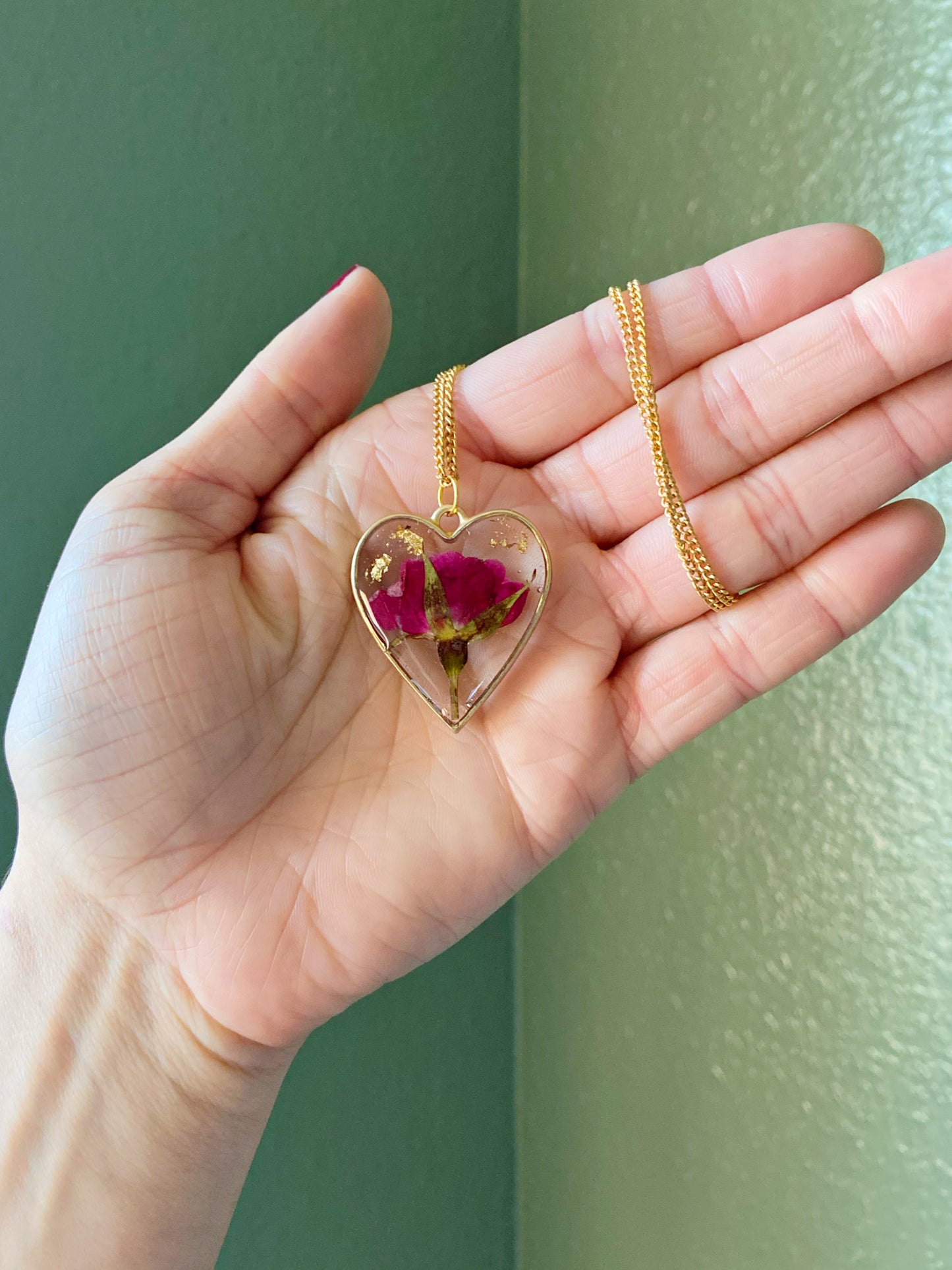 Roses- Red pressed rose buds & gold flake inside gold open heart-shaped matte pendant, 16" gold-plated chain included