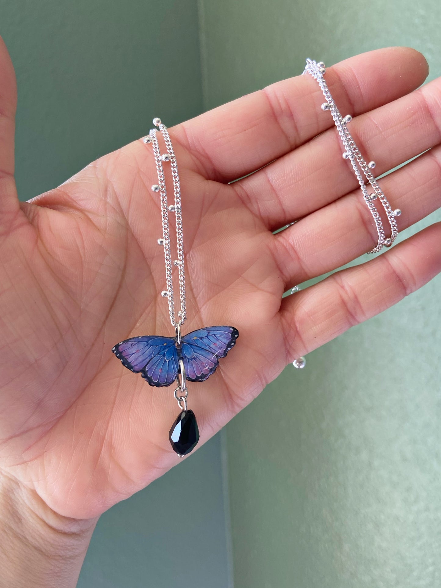 Mini Butterflies- Upcycled paper blue & purple morpho butterfly pendant with black glass bead dangle, 17" sterling silver plated chain included