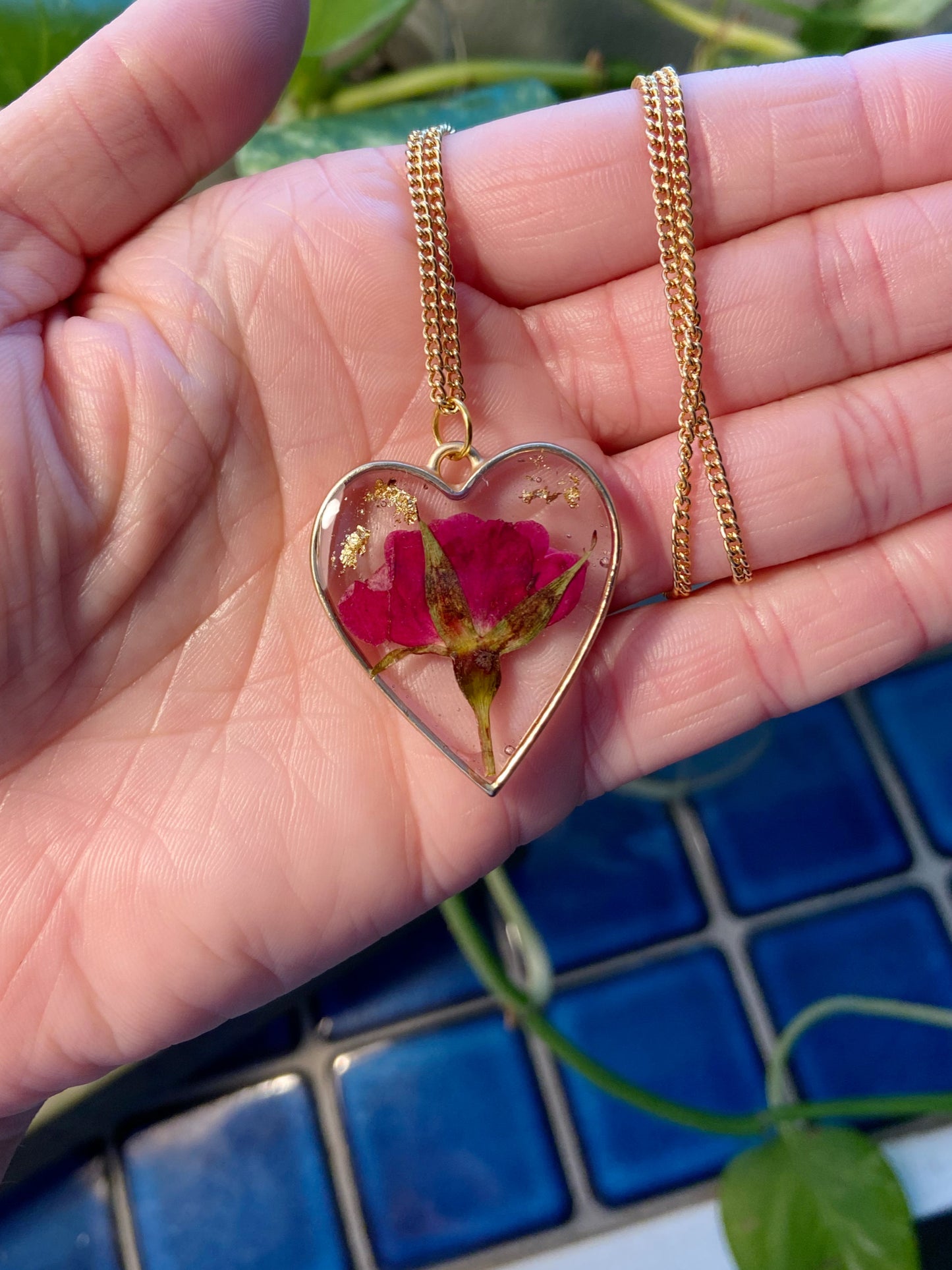 Roses- Red pressed rose buds & gold flake inside gold open heart-shaped matte pendant, 16" gold-plated chain included