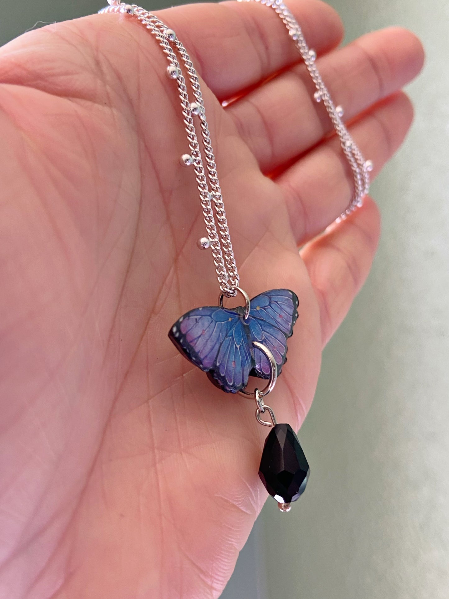 Mini Butterflies- Upcycled paper blue & purple morpho butterfly pendant with black glass bead dangle, 17" sterling silver plated chain included