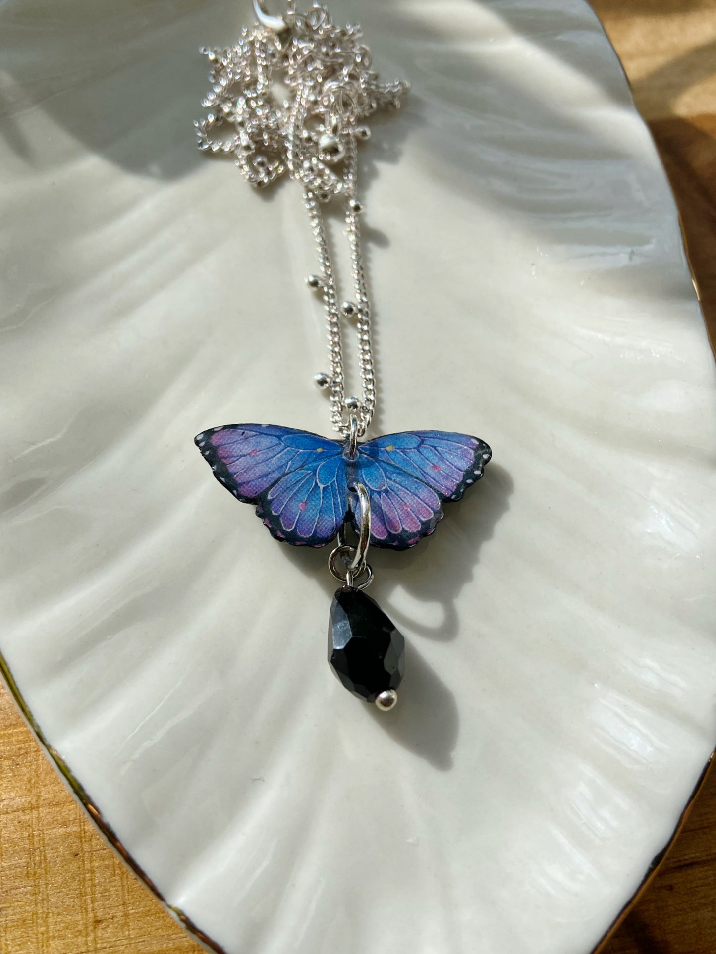 Mini Butterflies- Upcycled paper blue & purple morpho butterfly pendant with black glass bead dangle, 17" sterling silver plated chain included