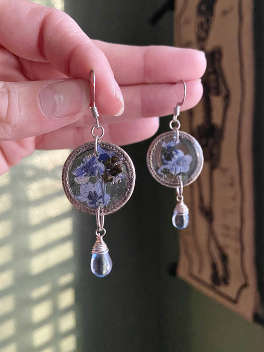 Forget Me Nots- Real blue flower clusters inside open silver leaf-patterned circle earrings with blue glass drop beads