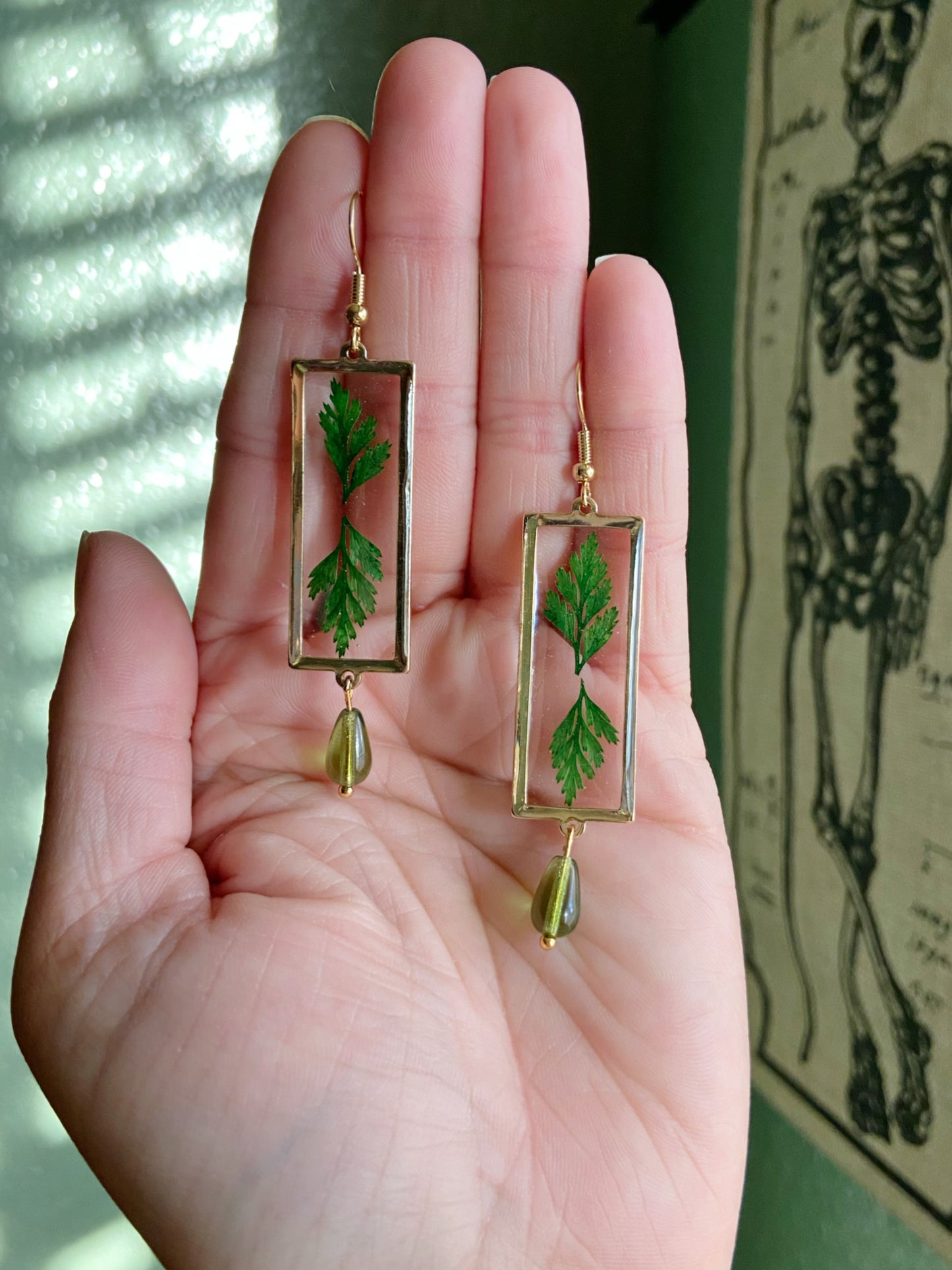 Greenery- Real pressed leaves symmetrically preserved inside long open gold rectangular earrings, olive green glass drop bead