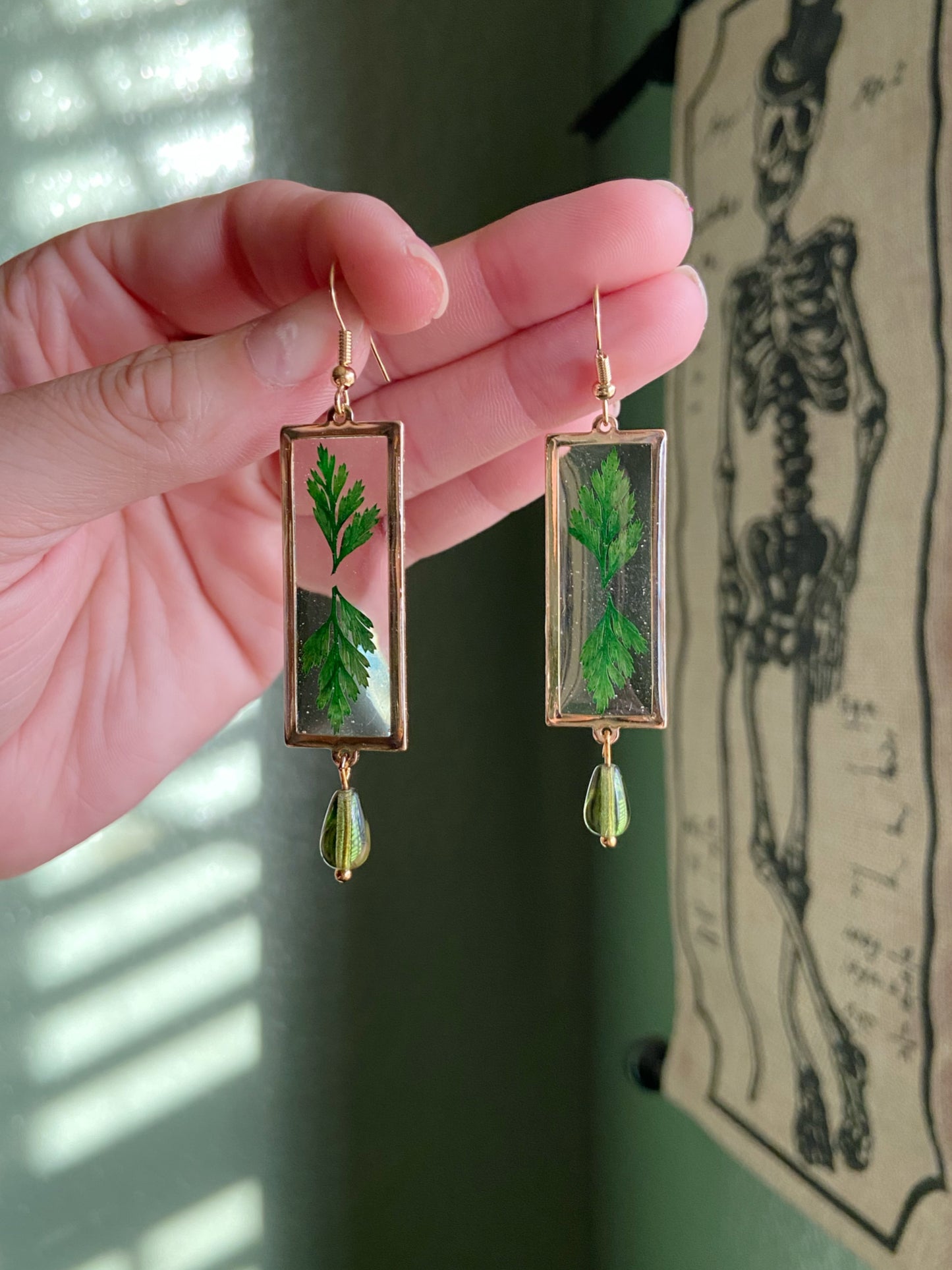 Greenery- Real pressed leaves symmetrically preserved inside long open gold rectangular earrings, olive green glass drop bead