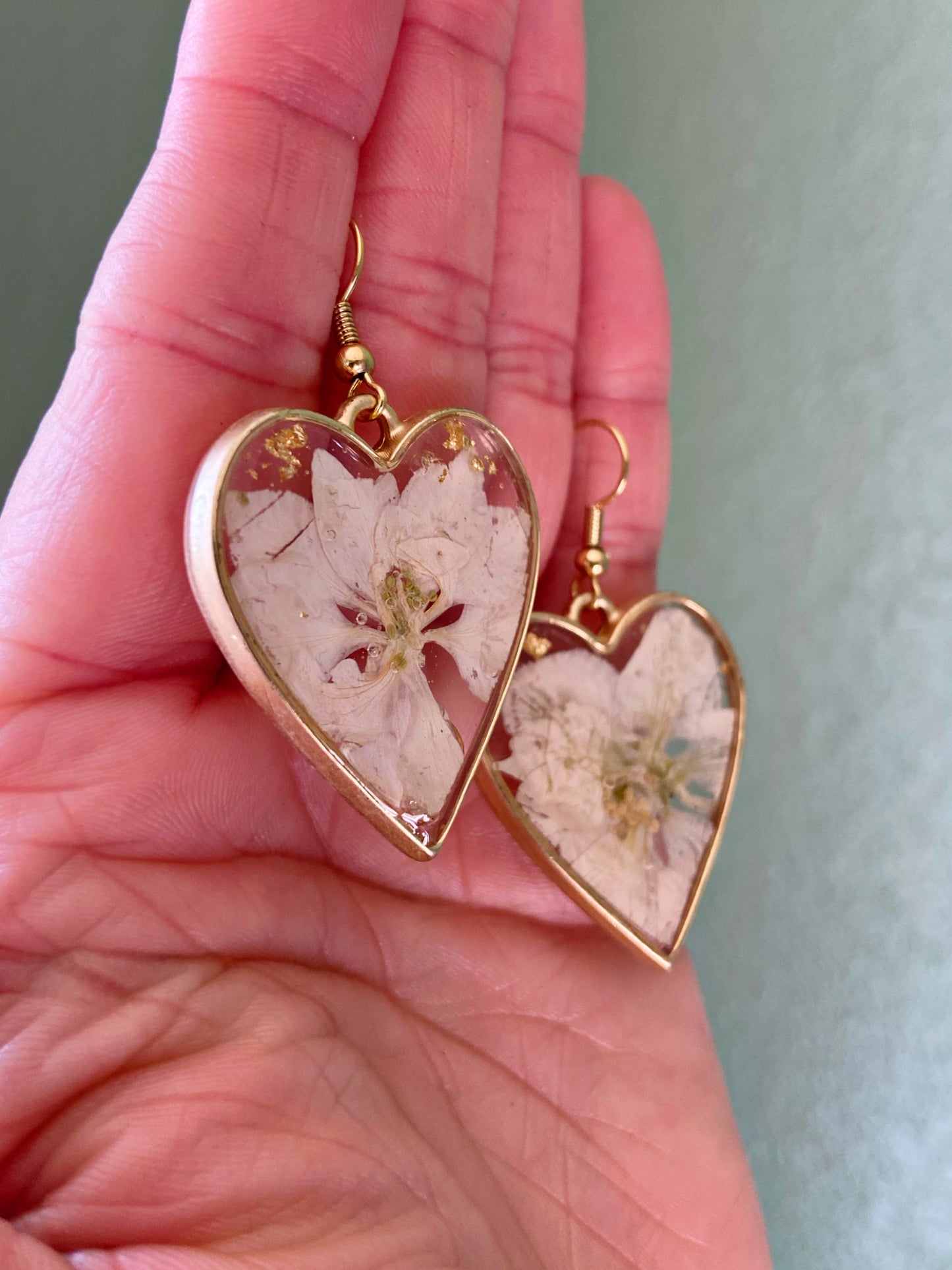Larkspur- White pressed flowers and gold flake inside open gold heart earrings, preserved botanical jewelry