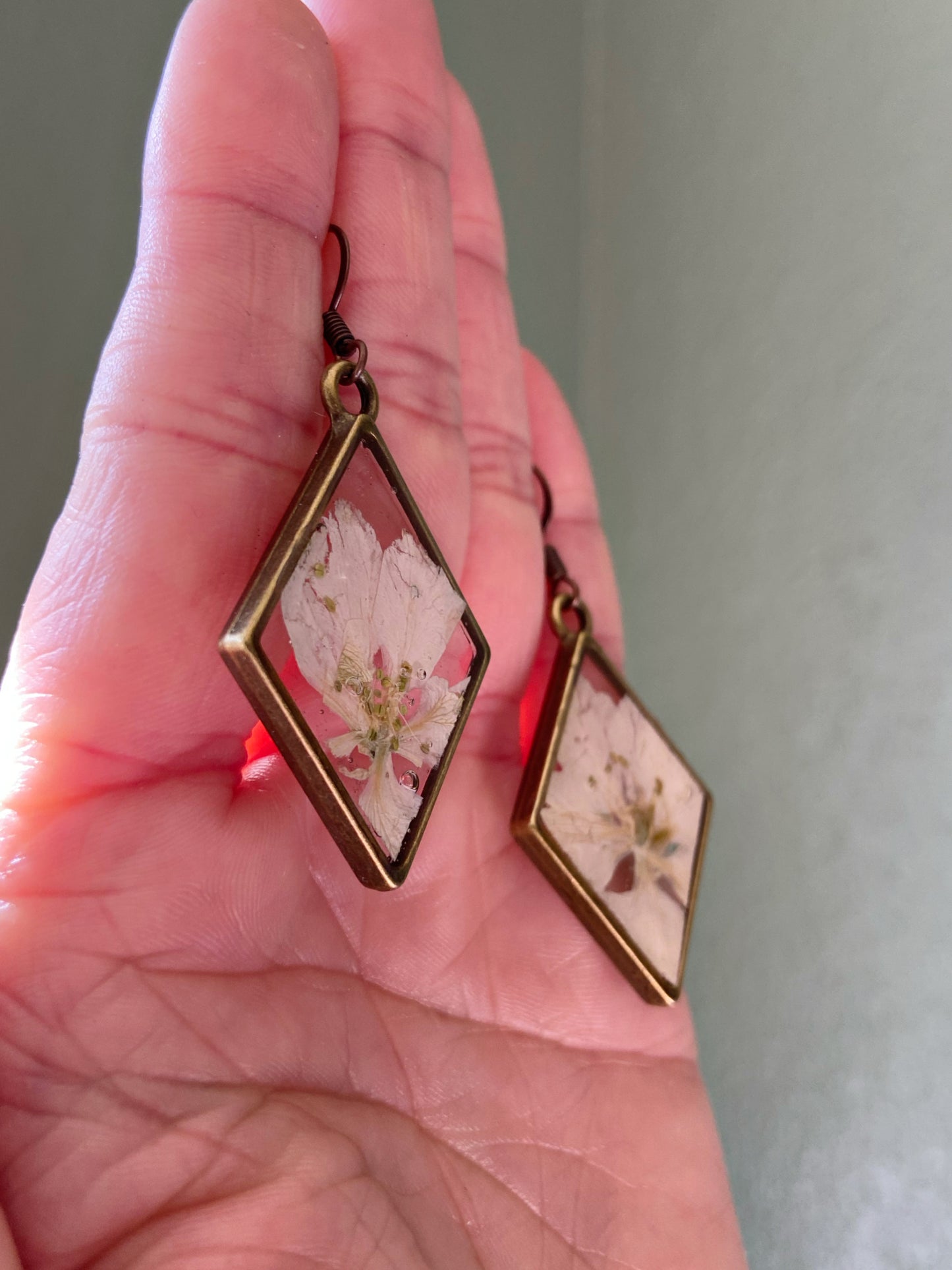 Larkspur- White pressed flowers inside bronze diamond shaped earrings, botanical nature lover jewelry